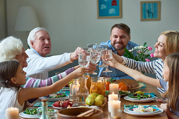Family enjoying pure, sustainable WOW water in the kitchen, illustrating the benefits of a premium water source
